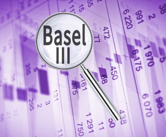 Magnifying lens over background with text Basel III, with the financial data visible in the background.