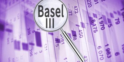 Magnifying lens over background with text Basel III, with the financial data visible in the background.