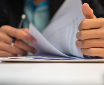 Start up learning for Document report business note in meeting room concept: Businessman manager hands writing for reading, signing in paperwork or documentation files at corporate on office desk