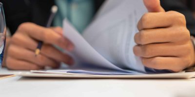 Start up learning for Document report business note in meeting room concept: Businessman manager hands writing for reading, signing in paperwork or documentation files at corporate on office desk