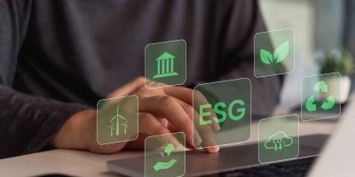 A person interacts with a digital interface showing icons related to ESG (Environmental, Social, Governance) principles.