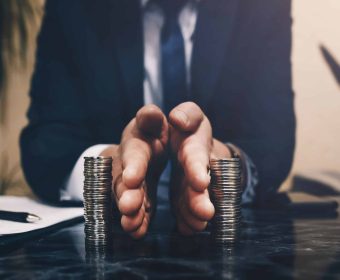 Businessman separates stack coins. Concept of  saving and investing.  Property division. Divorce and legal services.