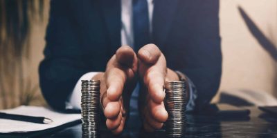 Businessman separates stack coins. Concept of  saving and investing.  Property division. Divorce and legal services.